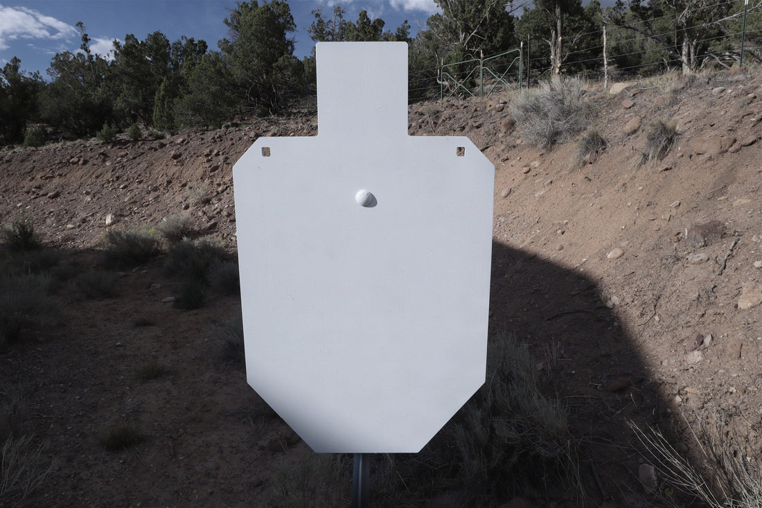 Full-size 1/2 inch AR500 IPSC silhouette on a T-post in front of a dirt berm