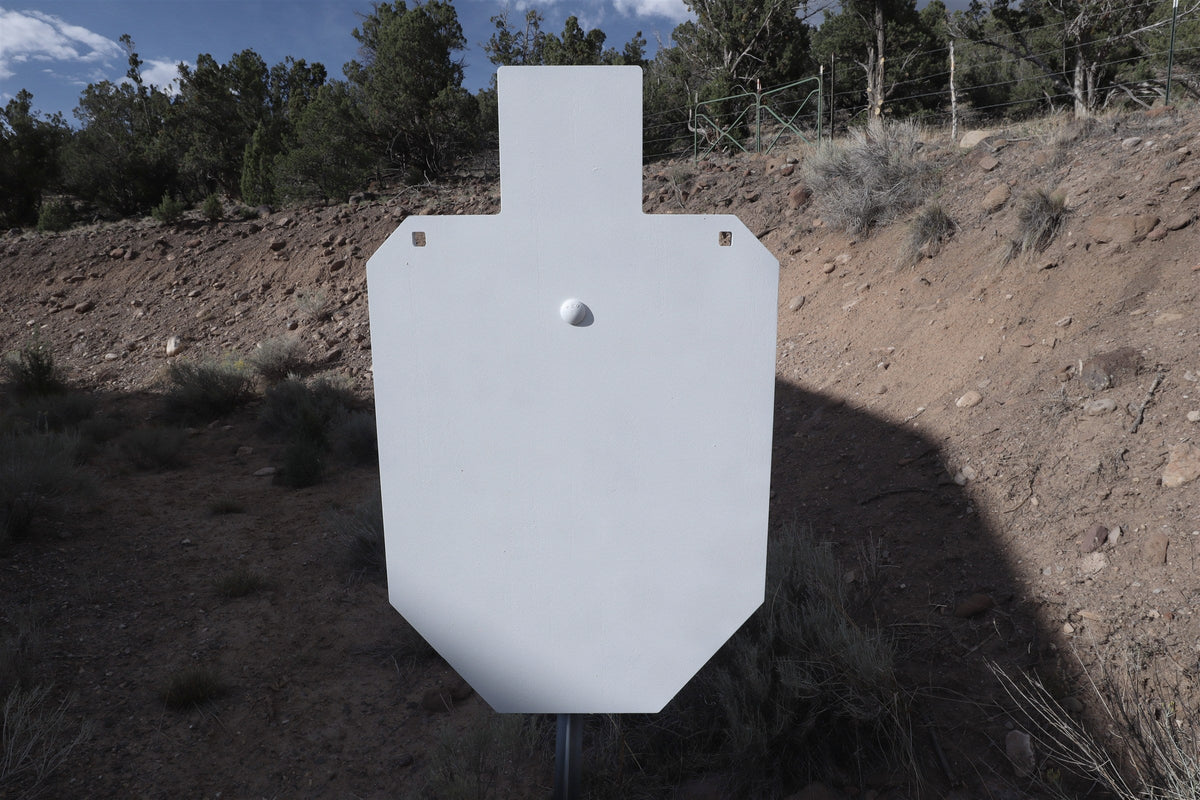 Full-size 1/2 inch AR500 IPSC silhouette on a T-post in front of a dirt berm