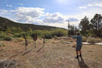 Wide view of a shooter at a range of Wyatt AR500 steel targets