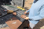 Real photo: range setup from a truck bed with Wyatt 1/2″ AR500 plates in red-oxide primer, T-post hangers with chain and bolts, a T-post and a post driver. Hangers and T-posts sold separately.