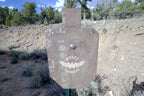 66-percent IPSC silhouette, 1/2-inch AR500 steel, surface rust, three 9/16-inch square mounting holes, mounted on a T-post