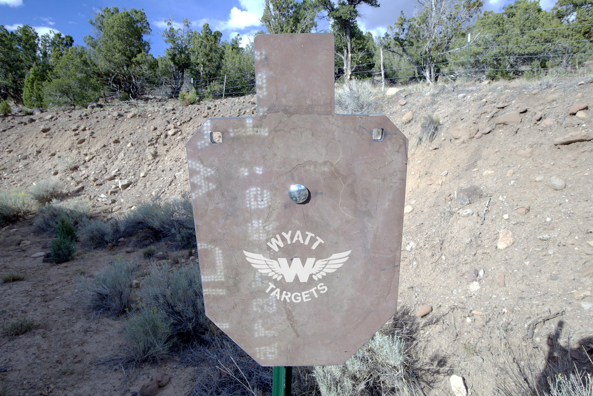 66-percent IPSC silhouette, 1/2-inch AR500 steel, surface rust, three 9/16-inch square mounting holes, mounted on a T-post