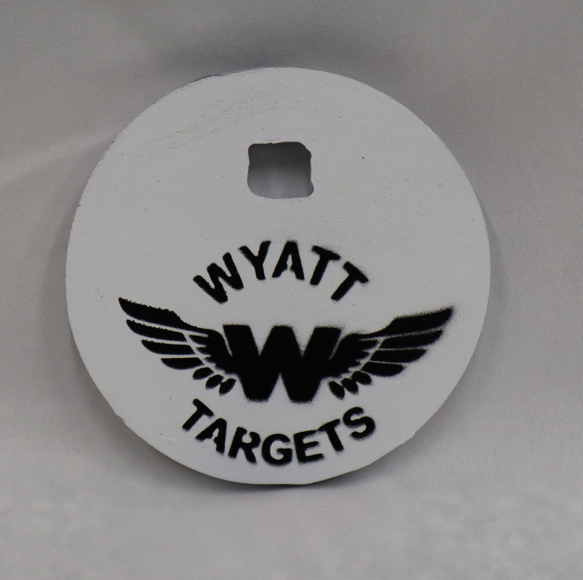 Real photo: 4″ 1/2″ AR500 steel gong, white paint with the Wyatt Targets logo
