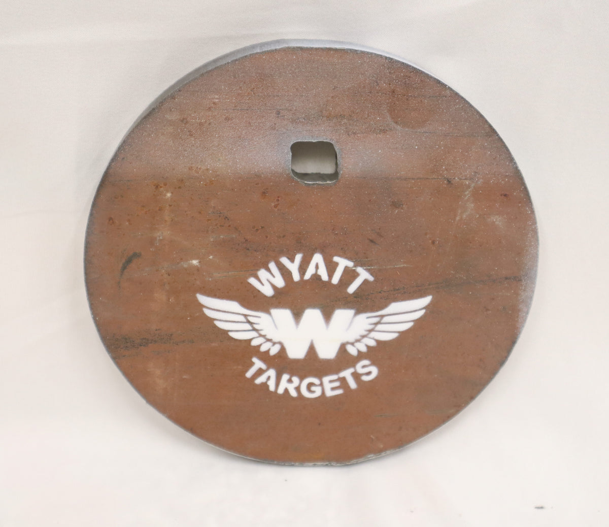 Real photo: 6″ 1/2″ AR500 steel gong, unpainted surface-rust finish with a white Wyatt Targets logo