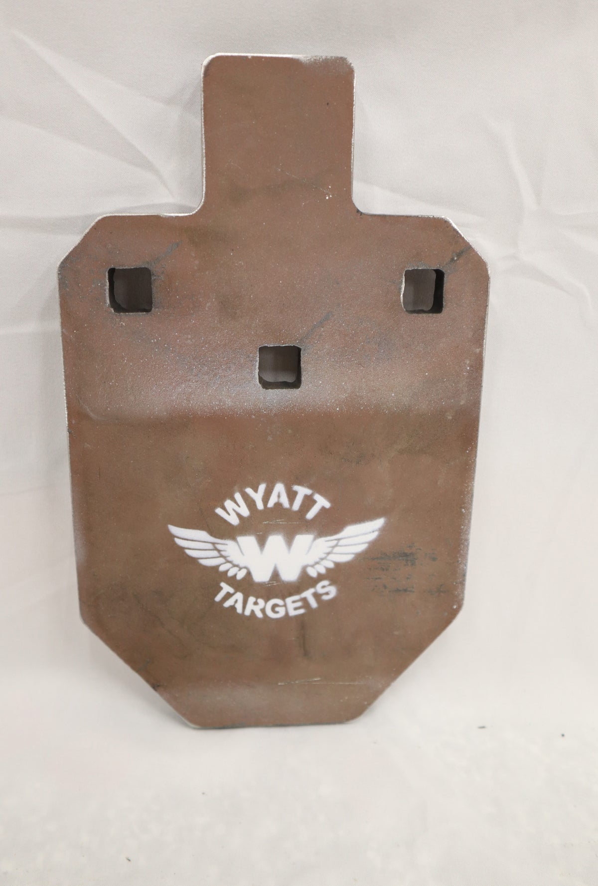 Real photo: IPSC 33% 1/2″ AR500 steel silhouette, unpainted surface-rust finish with a white Wyatt Targets logo
