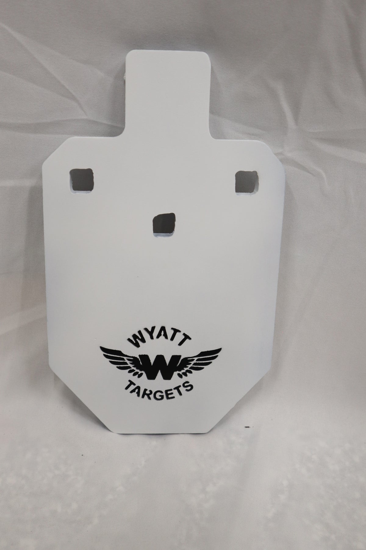 Real photo: IPSC 33% 1/2″ AR500 steel silhouette, white paint with the Wyatt Targets logo