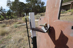 Real-life installation example: the back of a target attached to the Wyatt T-post hanger system. Hangers and T-posts are sold separately; this Triple Steal Deal includes three plates only.